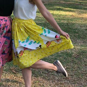 Pinup Couture Jenny Skirt in Mary Blair "Bon Voyage" Yellow Train Print, Small